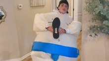Boy struggles to put on shoes after wearing costume and ends up falling