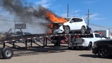 Dramatic footage shows a car engulfed in flames outside an auto auction facility