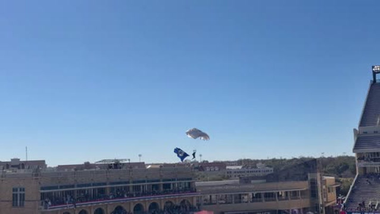 Skydiver makes a hard landing after getting caught in net while parachuting into college football Armed Forces Bowl