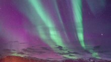 Northern lights illuminate the night sky with colors straight from a dream