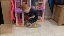 Little boy tries to sit on a Barbie chair and ends up falling adorably