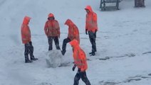 Amsterdam Schiphol staff play in snow as wintry weather causes travel chaos