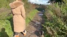 Woman's struggle to stay upright on slippery mud ends in a messy manner