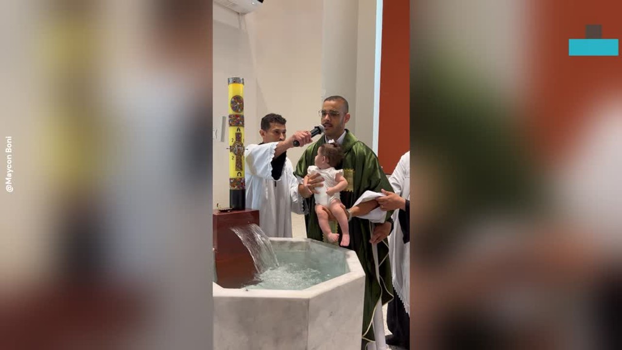 Shocked Baby Is Baptized by Immersion in Church Ceremony