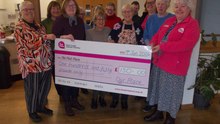 Our Place cancer support group in Alton presents a cheque for £150 to The Pink Place cancer charity