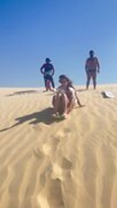 Women Fall While Sandboarding