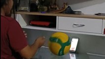 Video shows girls practicing volleyball remotely with creative use of phone and ball