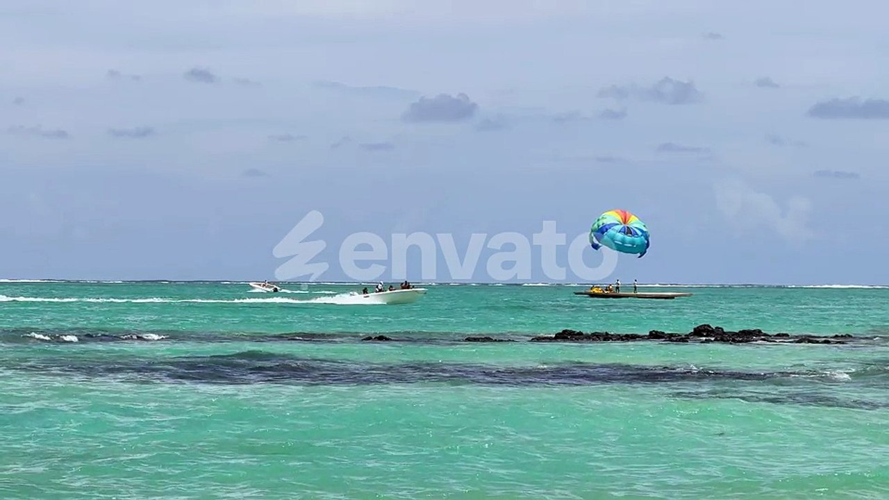 Parasailing and Speedboat on Turquoise Ocean
