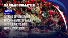 Catholic devotees wade through waters of Laguna Lake during Sto. Niño fluvial procession