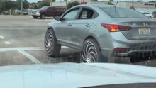 Unconventional rims on a car create a humorous and eye-catching moment on the road