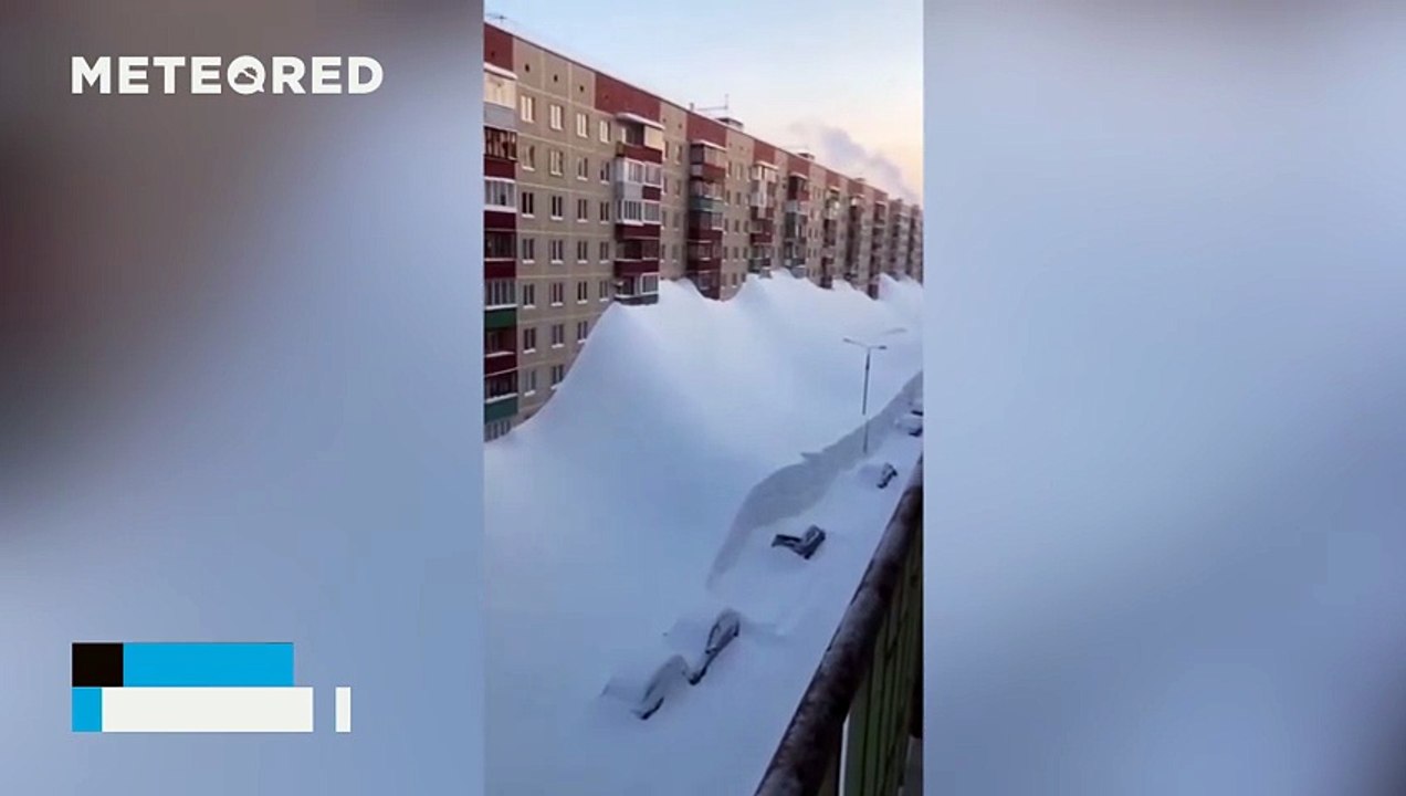 A major snowstorm blankets the streets and buildings of Kamchatka, Russia
