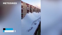 A major snowstorm blankets the streets and buildings of Kamchatka, Russia