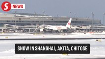 Cold wave brings rare snowfall to Shanghai, disrupts Japan's flights and trains
