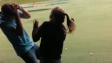Boy teaches his sister to swing a golf club and gets hit hard