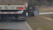 Trash truck operator struggles to set a bin upright and ends up knocking it over