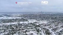 Drone footage shows snow-covered US cities, snow plows at work
