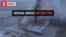 Drone video of thick smoke engulfing town after factory fire in central Greece