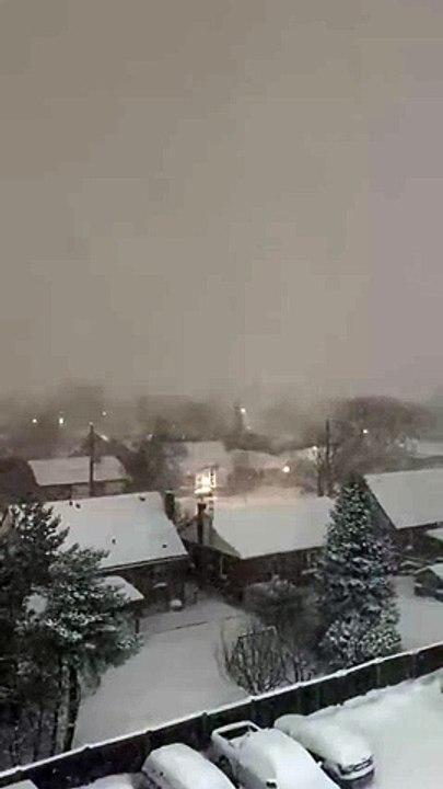 Heavy nighttime snowfall blankets neighborhood during blizzard in Hamilton, Ontario, Canada