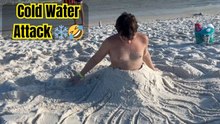 Lad's reaction to getting ice-cold water poured on him at beach is HILARIOUS!