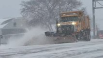 Snowplows clear roads during winter storm in Buffalo, New York, USA