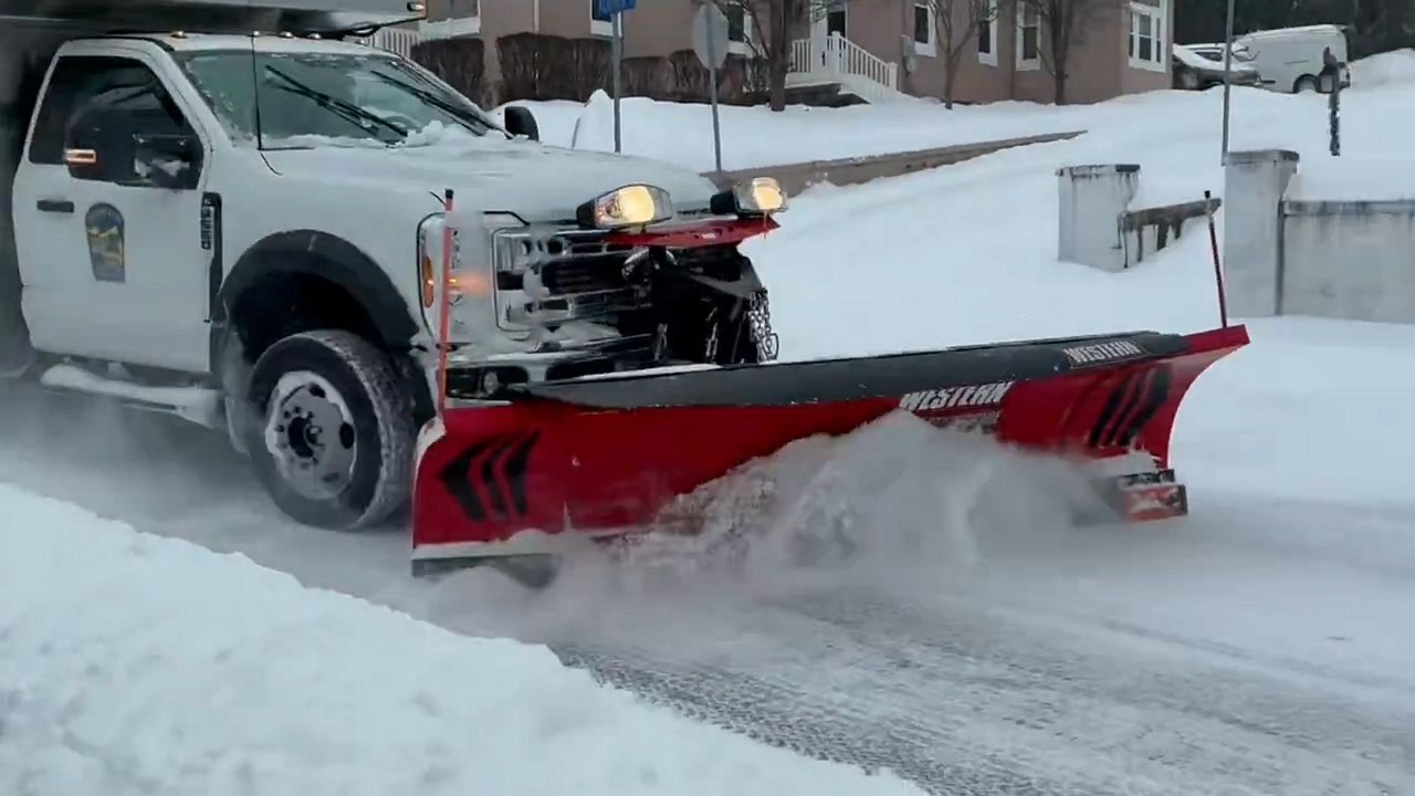 Snowplow clears heavy snow during winter storm...