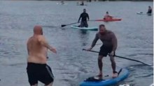 Man falls from a paddleboard after another man runs into him