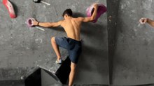 Climber falls as a hold breaks during an ascent on an indoor climbing wall