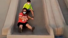 Mom joins her son on a slide and experiences a bumpy finish