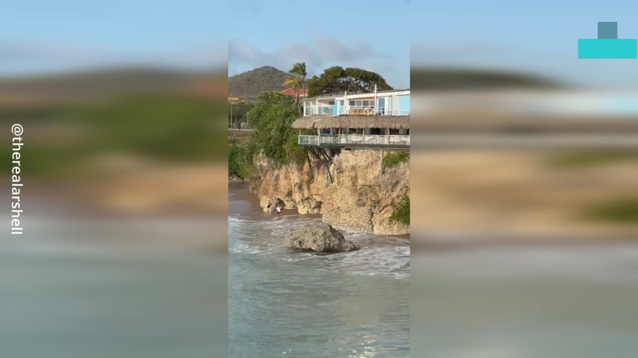 Couple Knocked Down by Huge Wave