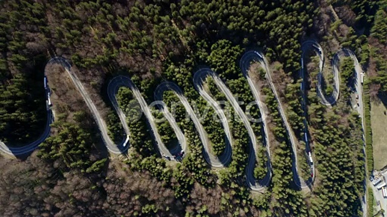 Bird's eye static aerial view of switchback highway over Bratocea Pass, Romania