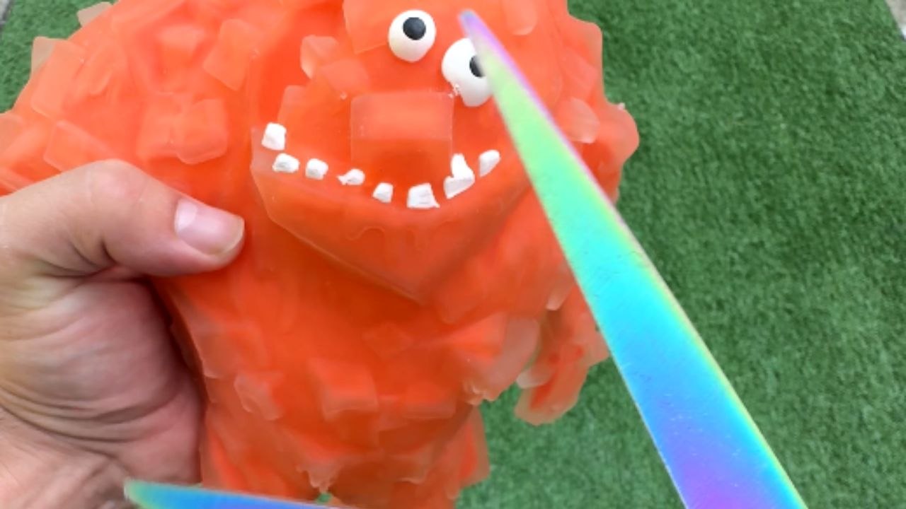 Water-filled rubber toy inflates and shakes until scissors cause a spectacular explosion