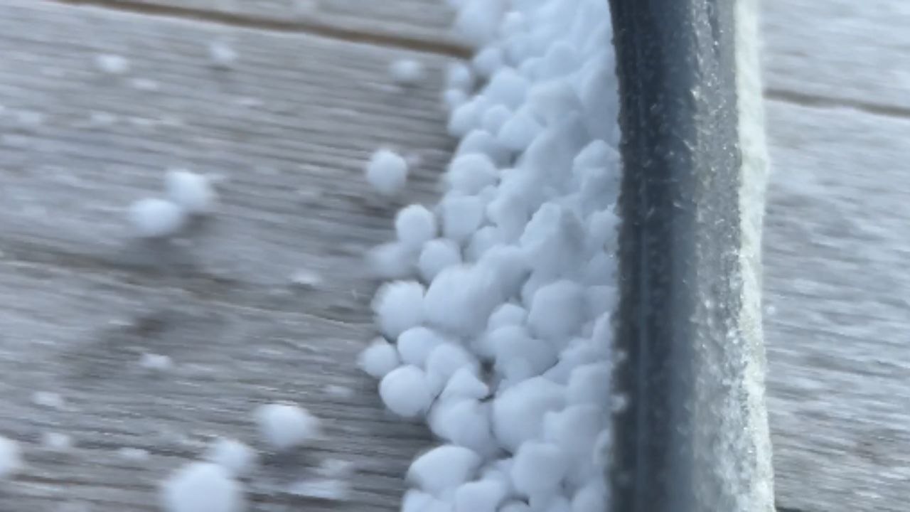 Individual uncovers the joy of gathering non-consumable Dippin' Dots while clearing snow from a table