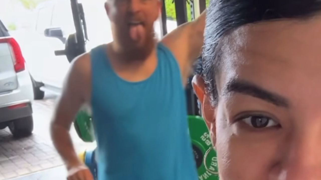 Fitness enthusiast preps for workout in the garage but knocks herself in the head