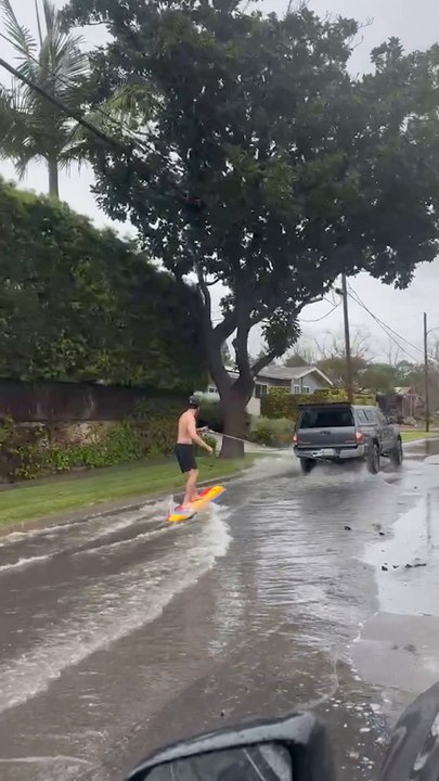 Surfer shreds flooded Long Beach streets after massive storm
