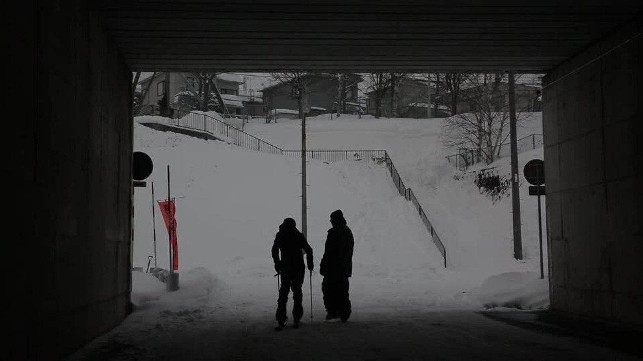 Person Walks Through Snowy Tunnel