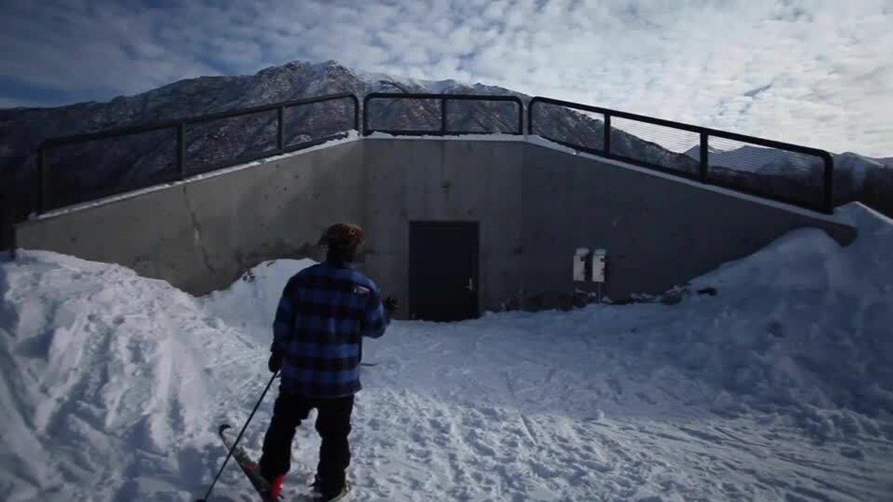 Skier Slides Down Railing After Jumping Ramp