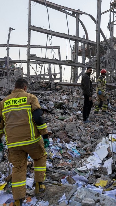 Damaged Buildings, Vehicles Seen After Strikes on Iran