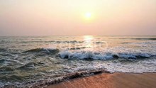 Slow Motion of Tropical Sea Waves Breaking on Empty Sandy Tropical Beach at Evening Sun