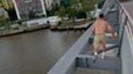 Parkour Athlete Jumps and Runs Across Top of Bridge in Brisbane, Australia