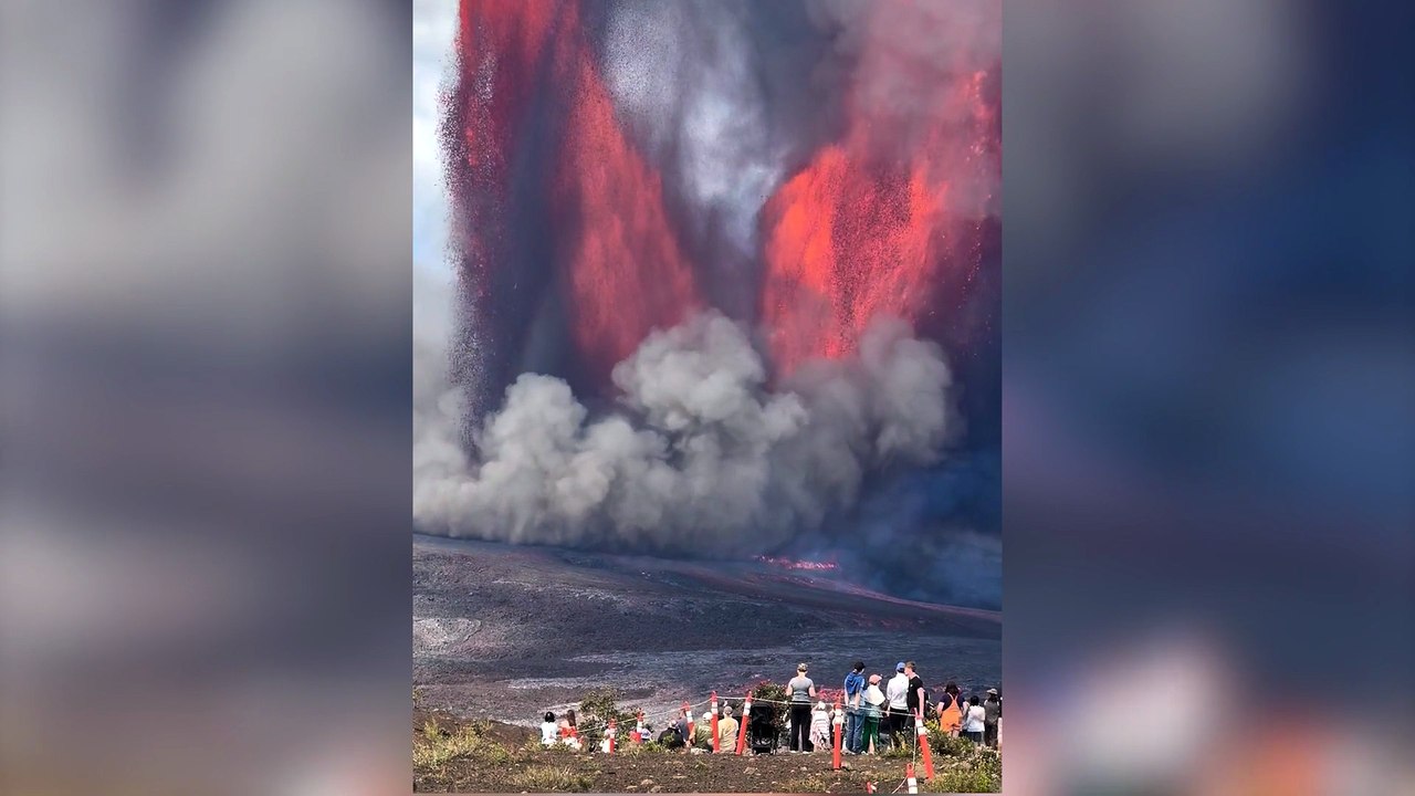 Crowd gathers to watch immense volcano eruption spewing lava into the sky