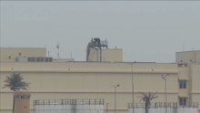 People clear objects from top of US embassy in Baghdad after missile attack