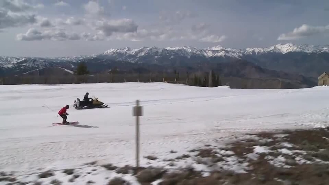 Skier Pulled by Snowmobile Does Flip
