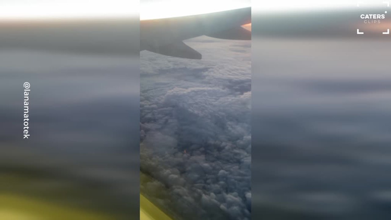 Eiffel Tower Peaks Through Clouds in Stunning View