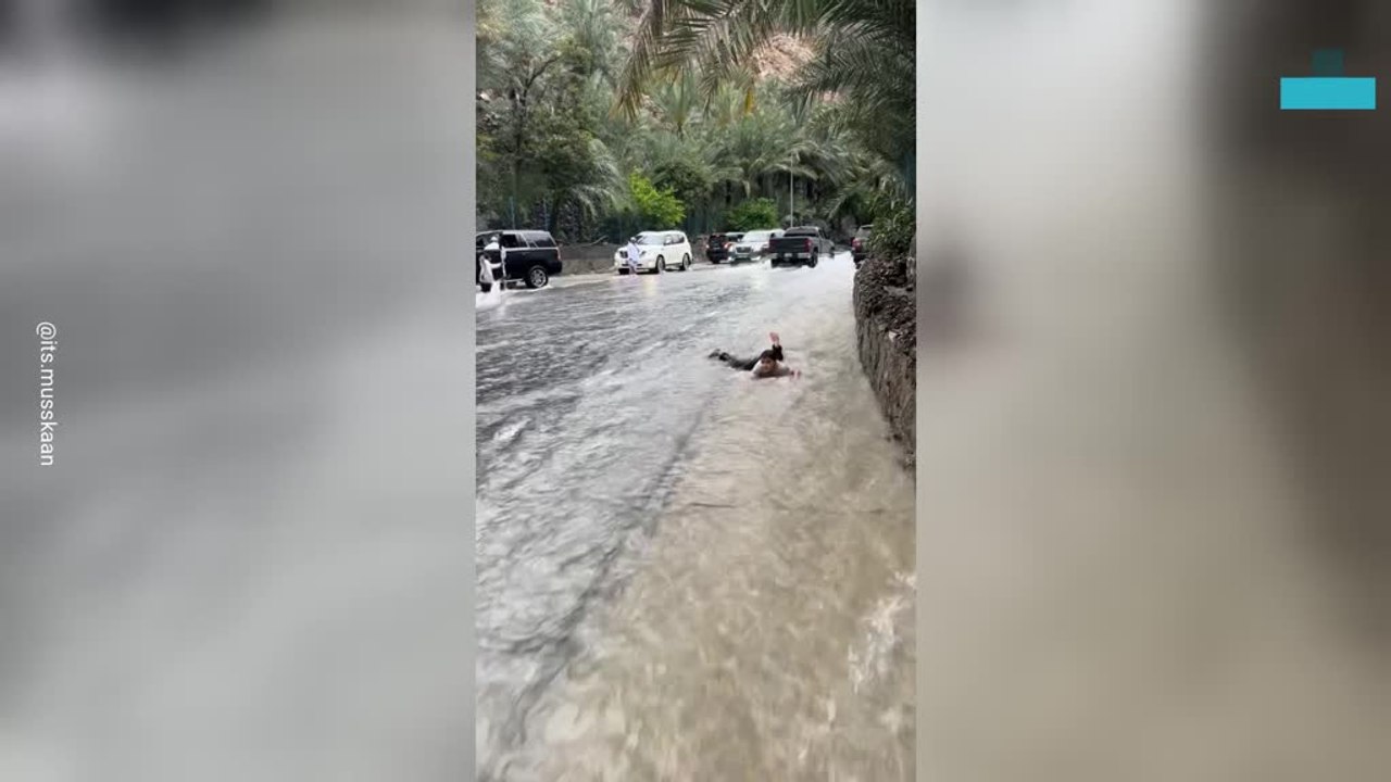 Kid Slides Through Flooded Streets