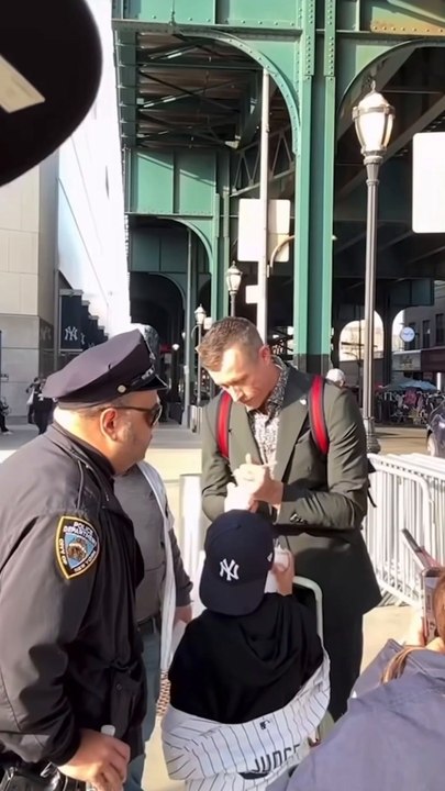Tim Hill signs autographs outside Yankee Stadium