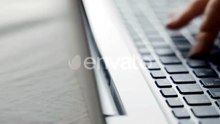 Woman Typing on Laptop Keyboard in the Office