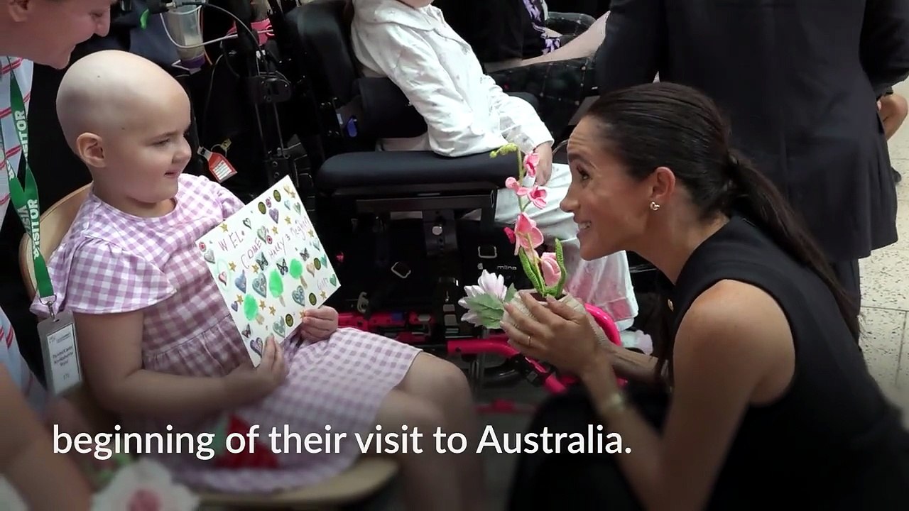 Harry and Meghan hug patients as hundreds greet them at children’s hospital