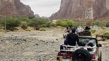 Scenic Desert Oasis of Wadi Disah with Clouds and Mountains