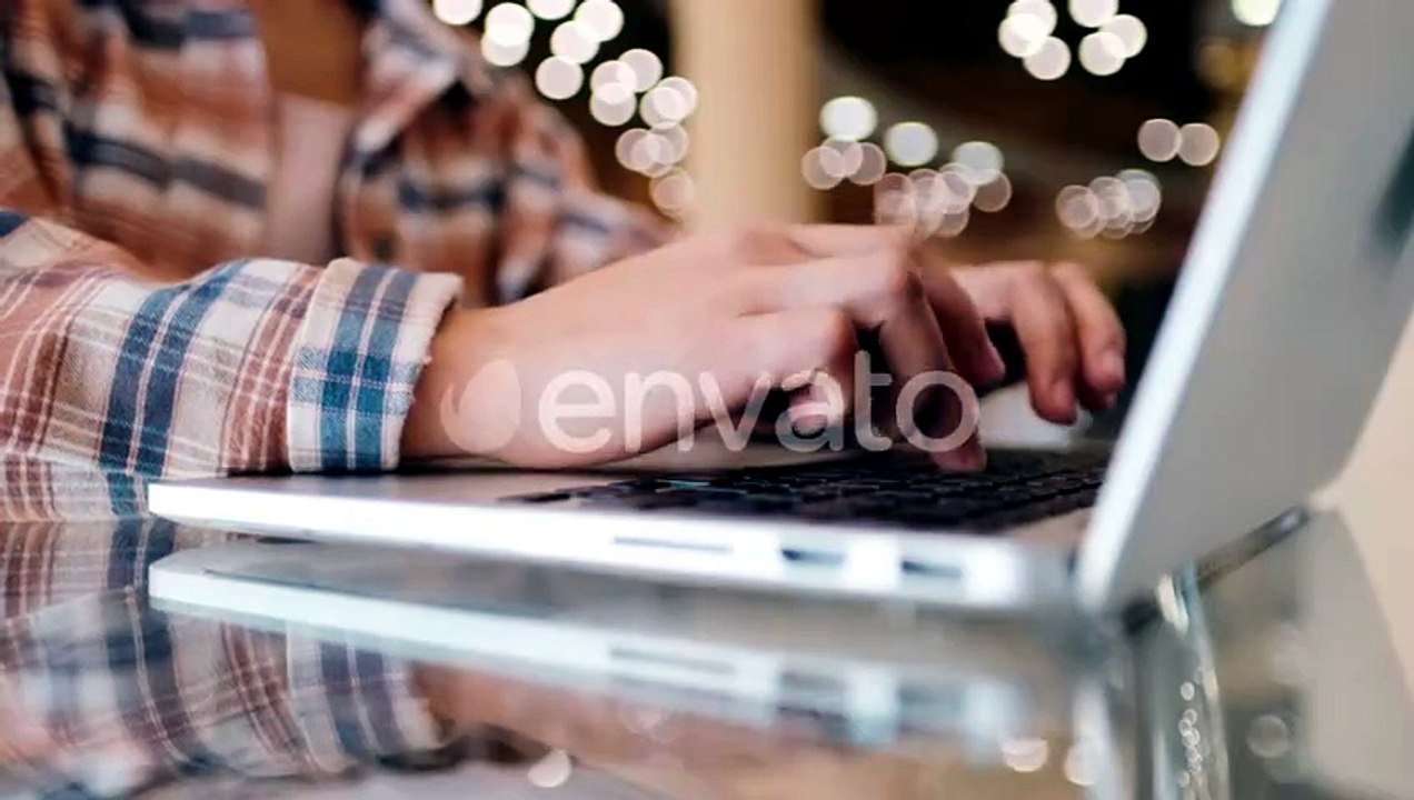 Close-up Woman's Hands Working with Laptop on the Desktop. Girl Blogger Freelancer Works in a Cafe