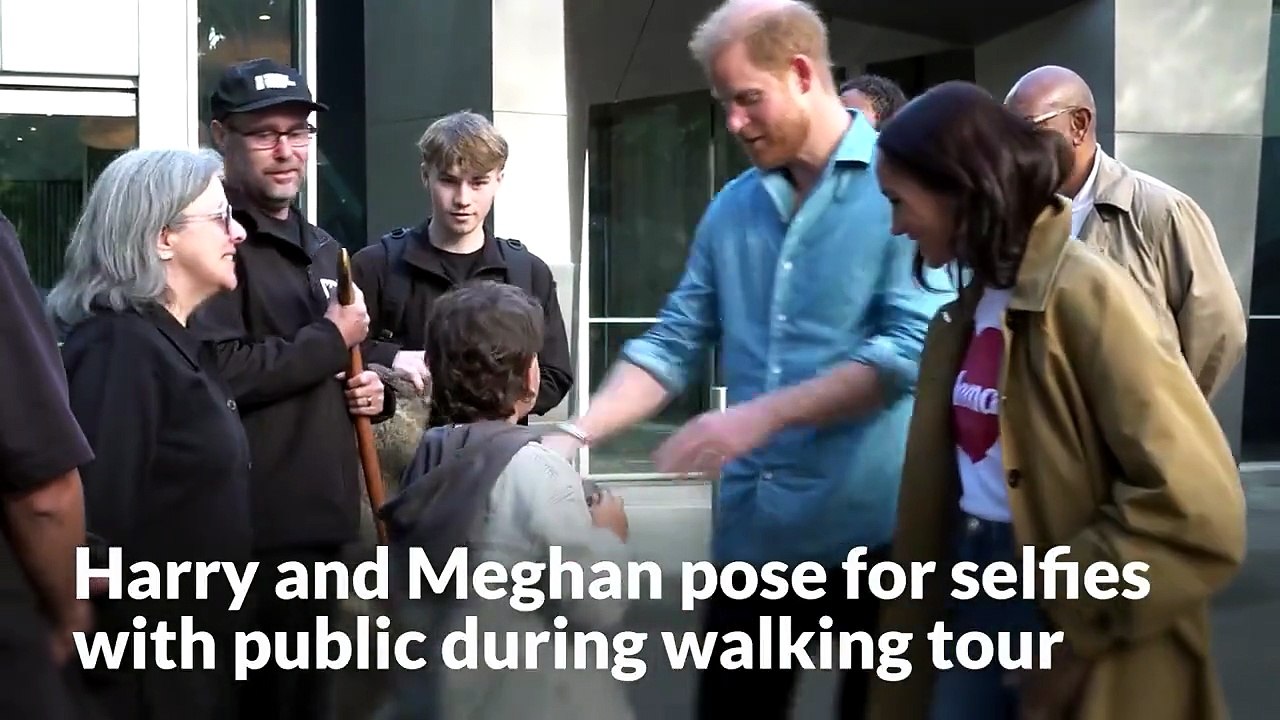 Harry and Meghan pose for selfies with public during walking tour